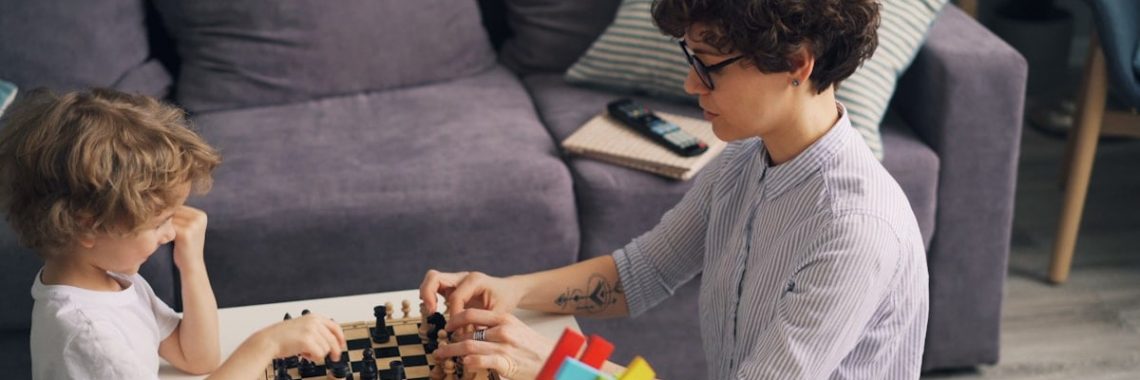 a boy and a girl playing a game of chess